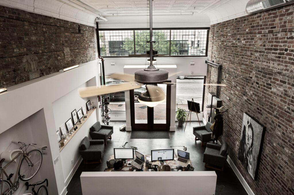 Loft office with exposed brick and ceiling fan